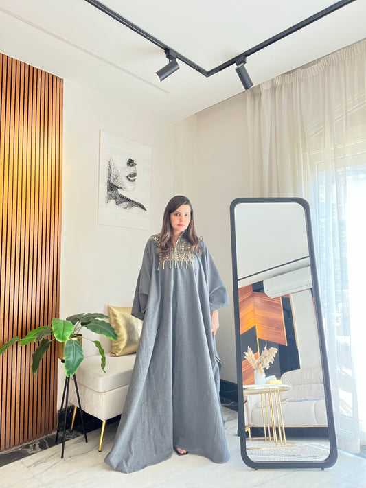 Striped linen abaya in dark grey, beige, and light blue tones.